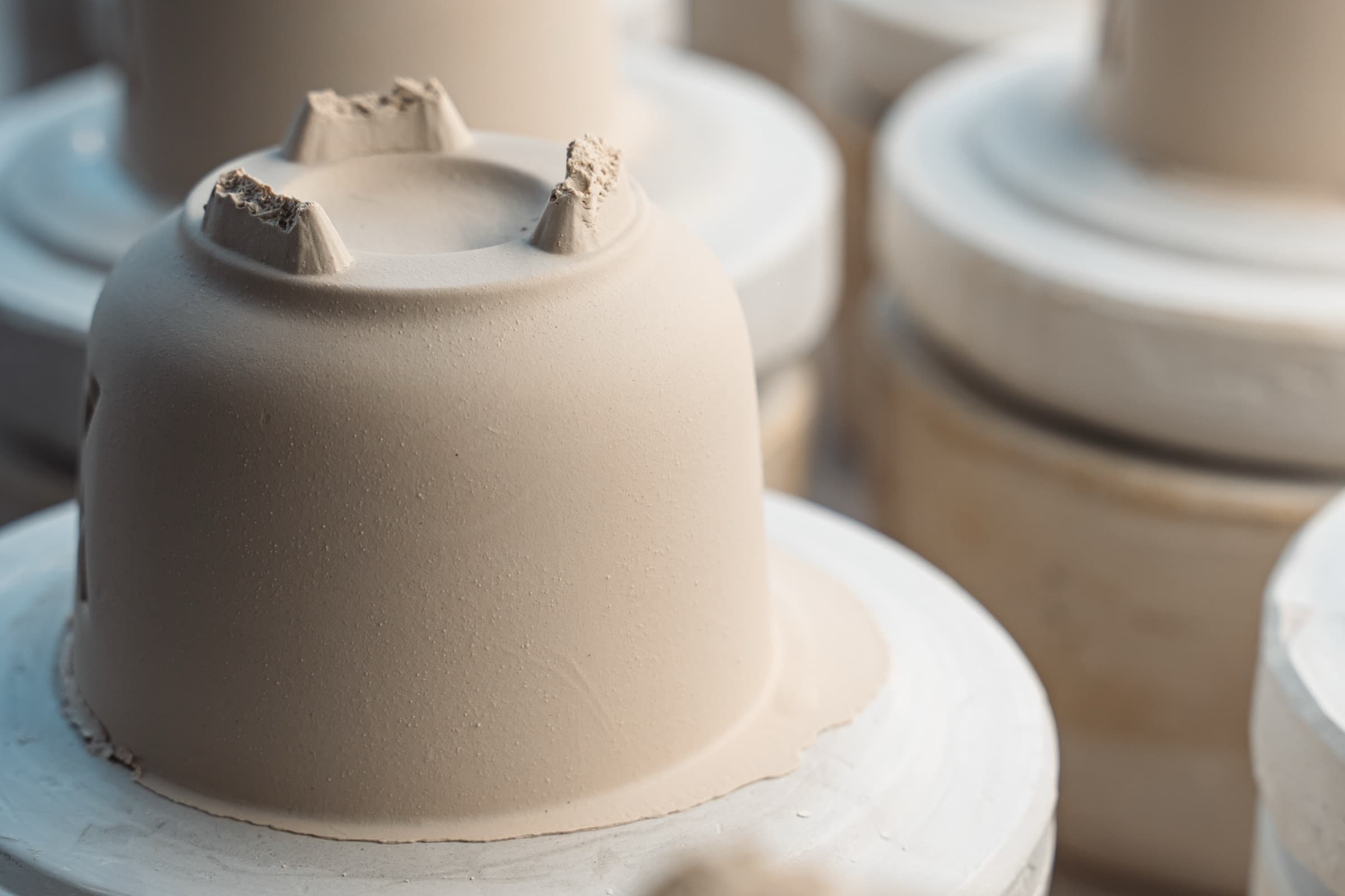 Porcelain cups lined up after firing